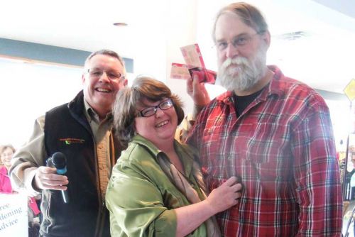 Denis Flanagan of Landscape Ontario presents Christine Kennedy and Gary Hay with two tickets to Toronto's Canada Blooms garden show